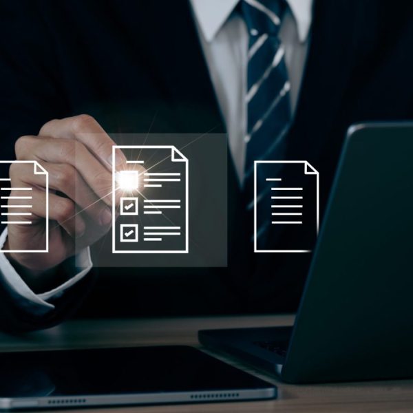 A businessman signs an electronic document on a digital document on a virtual notebook screen using a stylus pen. Paperless workplace idea, e-signing, electronic signature, document management. E-document management Paperless workplace.